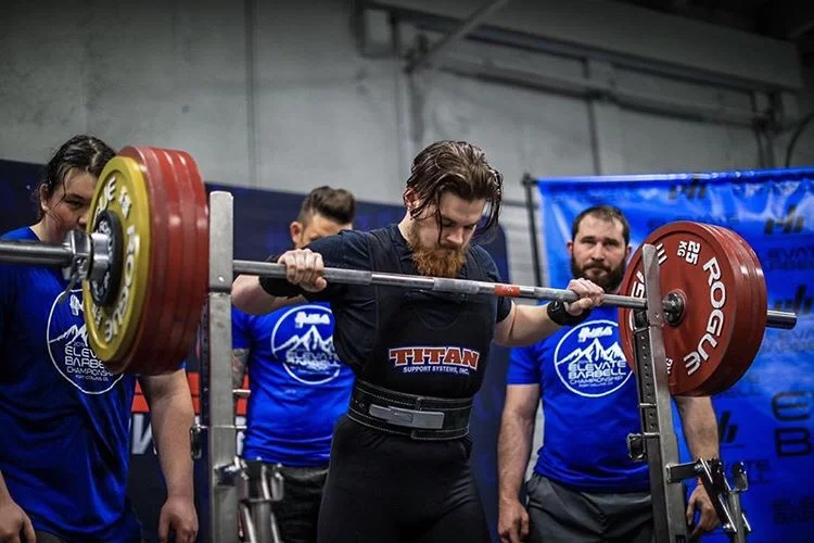 Matt Cronin's athlete setting up a squat at a powerlifting meet